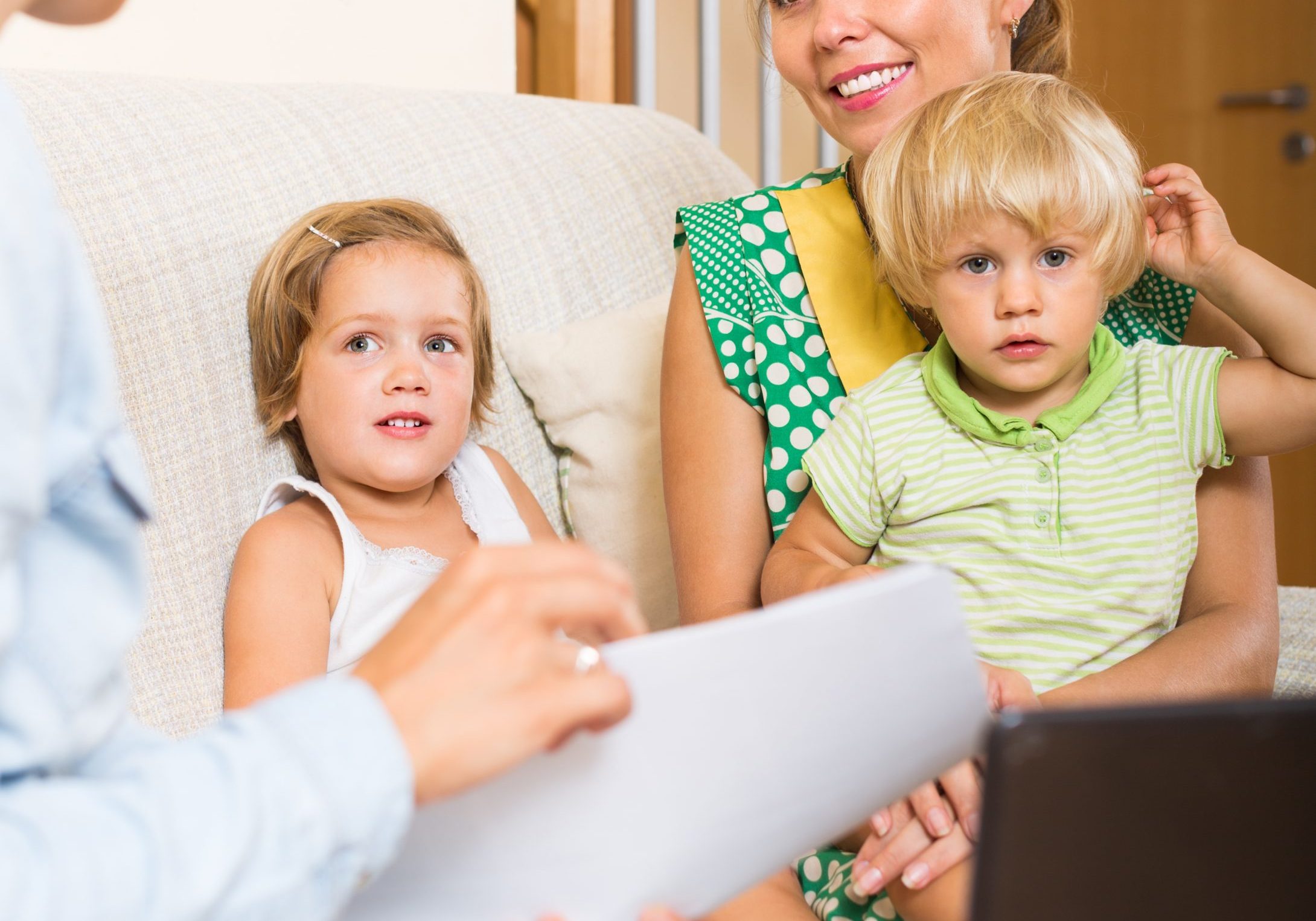 Agent helping happy mother with two children to obtain insurance