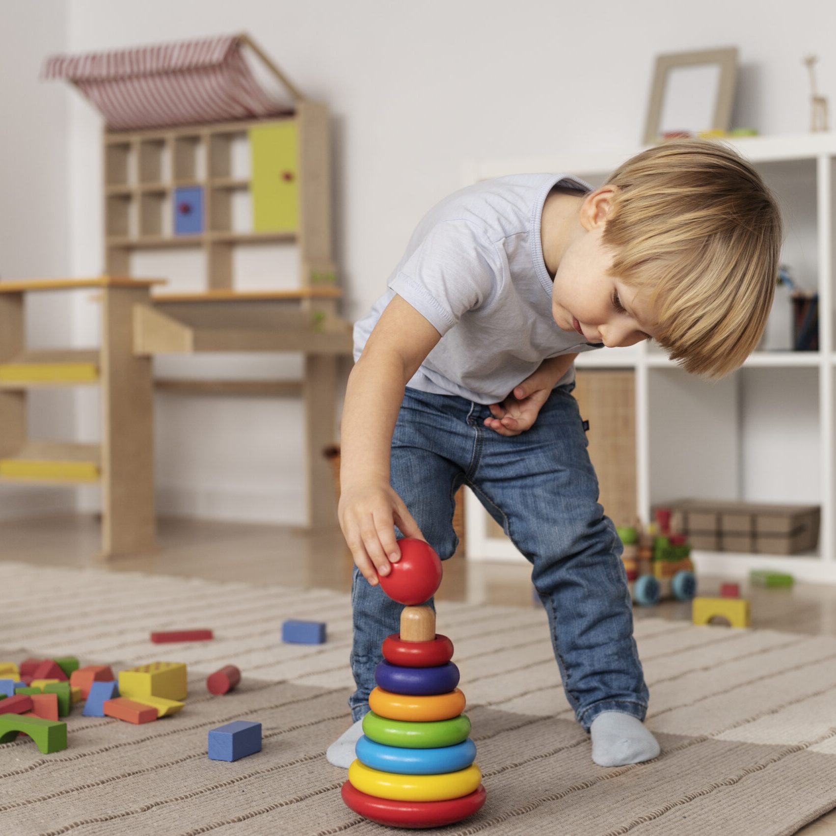 full-shot-kid-playing-floor-with-wooden-toy