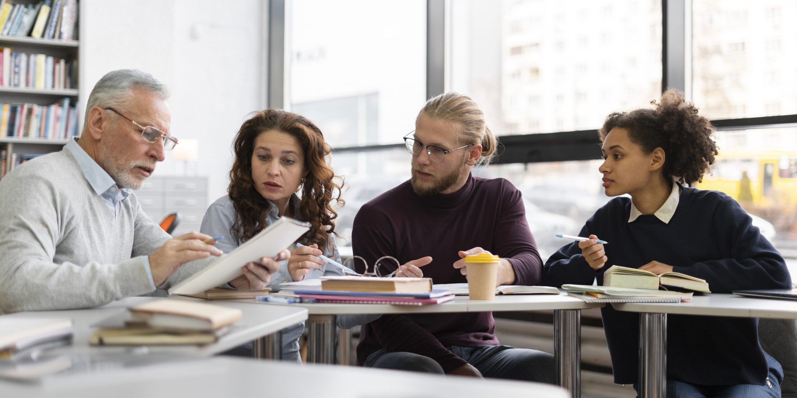 medium-shot-people-sitting-library